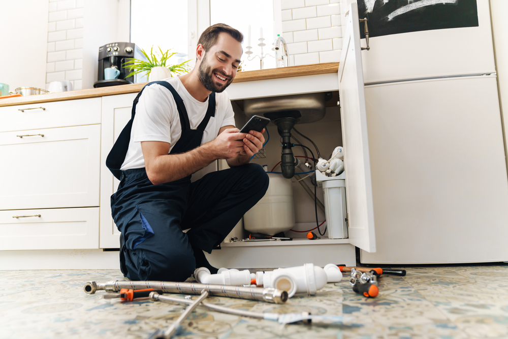 plumber on a phone maximizing productivity with a scheduling software